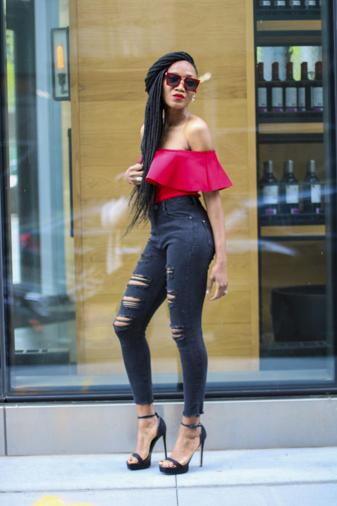 Ms Rexti in black ripped jeans and red bardot top