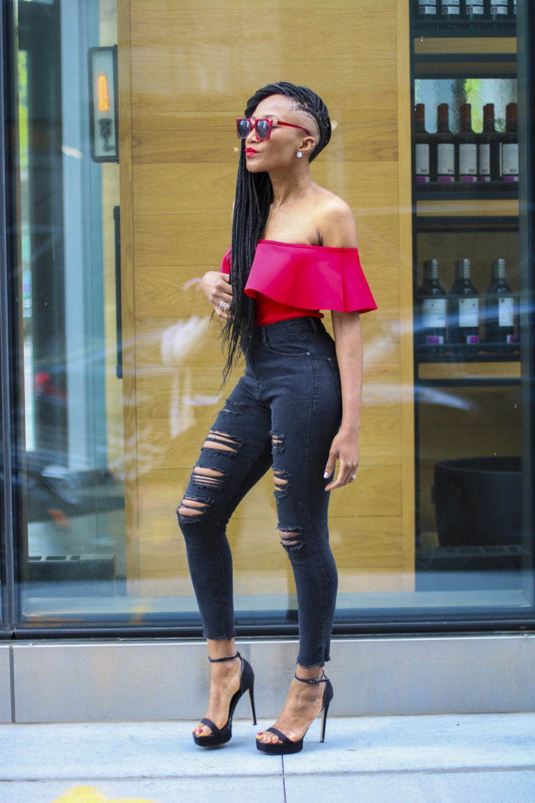 Ms Rexti in black ripped jeans and red bardot top