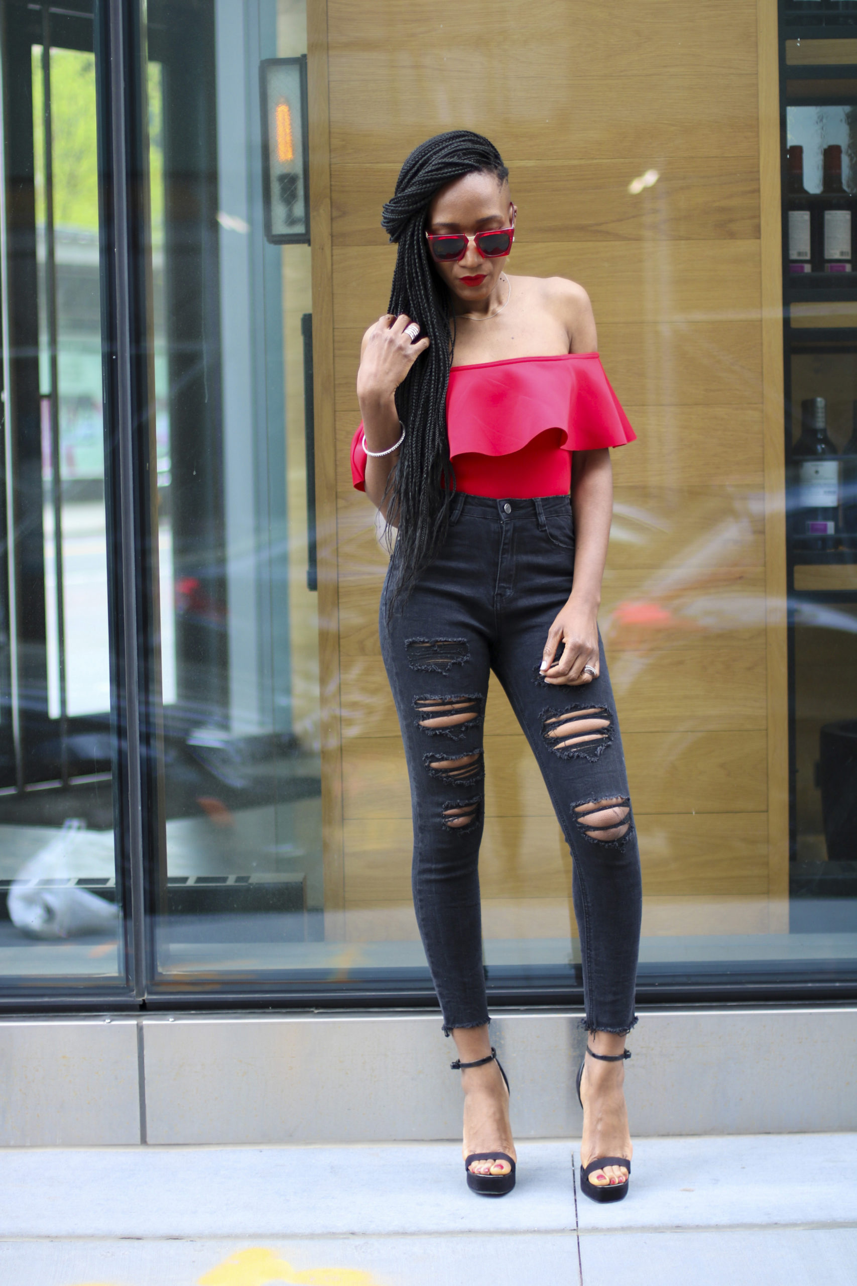 Ms Rexti in black ripped jeans and red bardot top