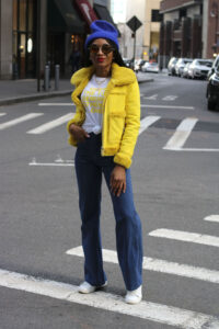 Ms Rexti wearing a canary yellow coat